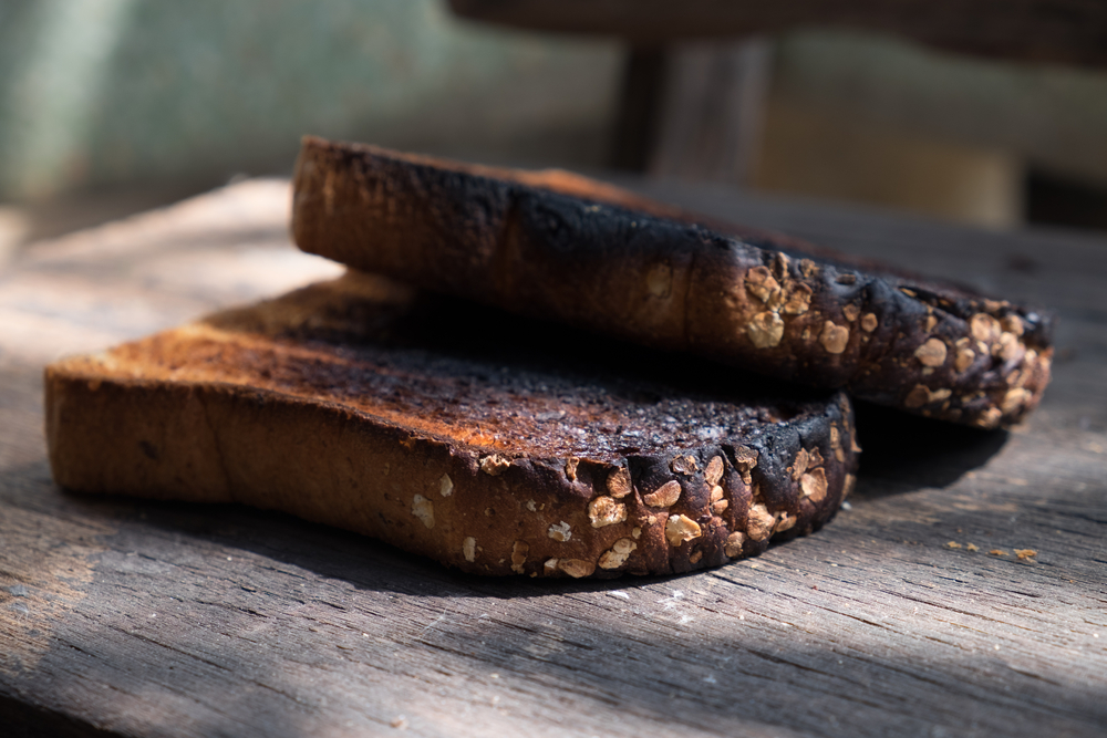 Scraping off burnt toast